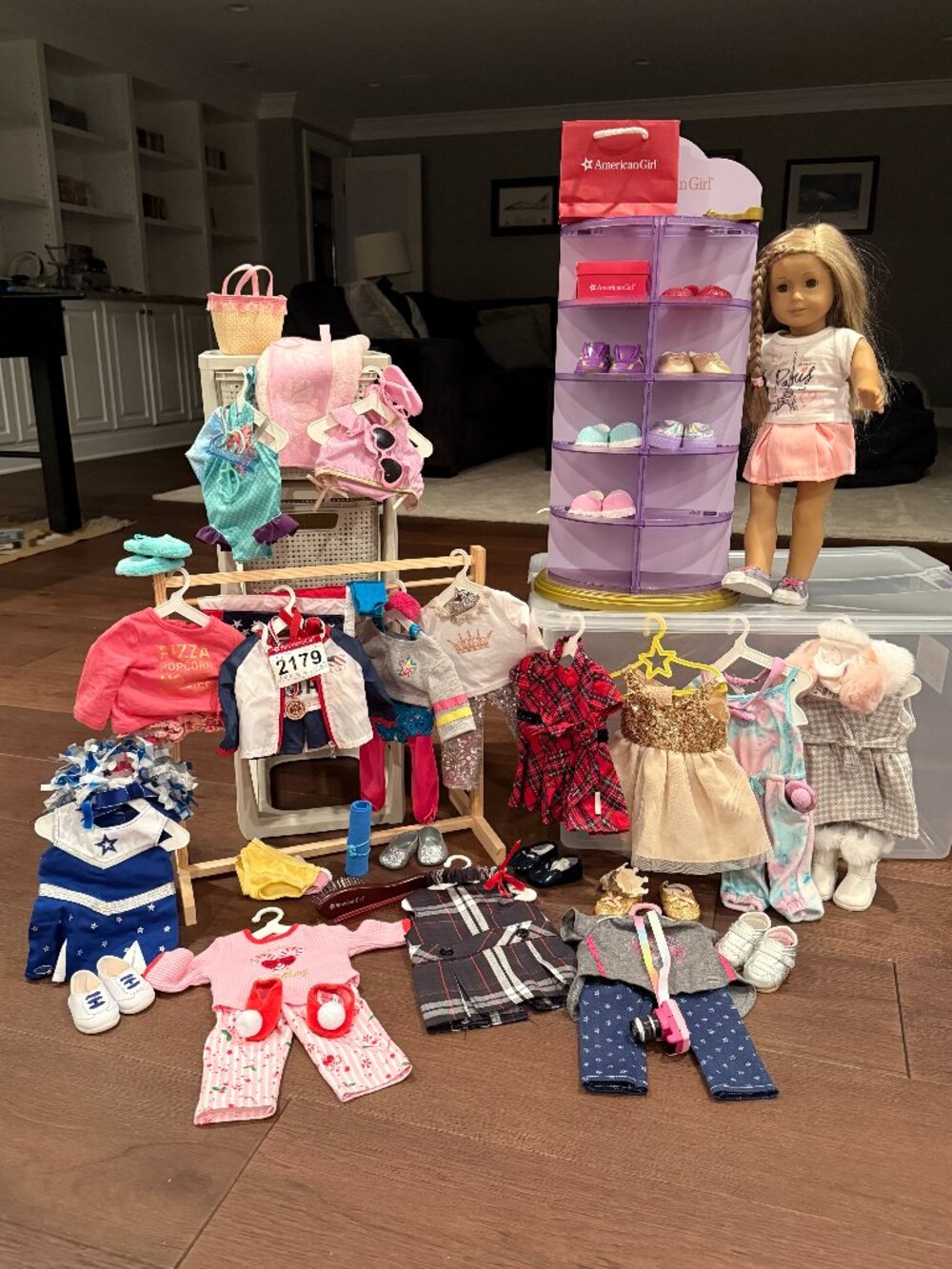 American Girl doll, shoe rack/mirror, 12 AG complete outfits.